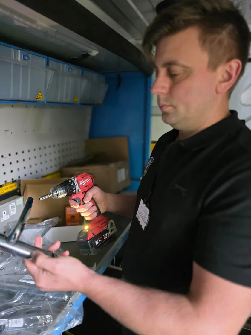 Cornel preparing parts in his van