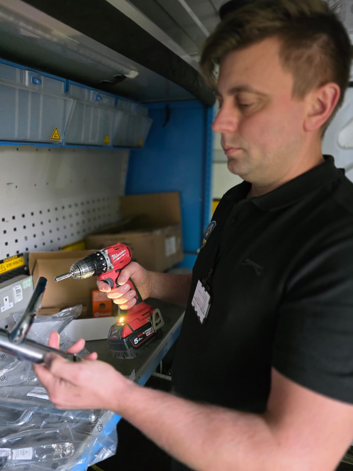Cornel preparing parts in his van